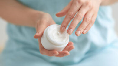 A person holding a skin cream