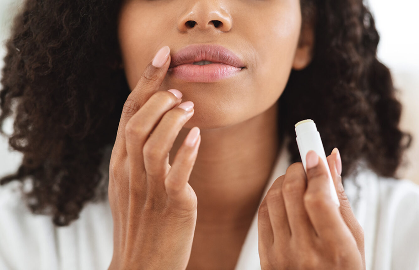 Woman applying Still Care Lipwear to her lips